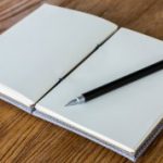 Book with pencil on a wooden desk