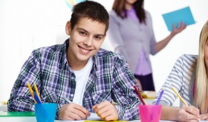 Portrait of happy lad looking at camera during lesson
